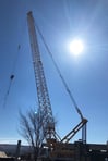 building the facility a crane lifts a building panel